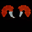 Photo of me standing in front of some Nanoleaf light panels in the dark